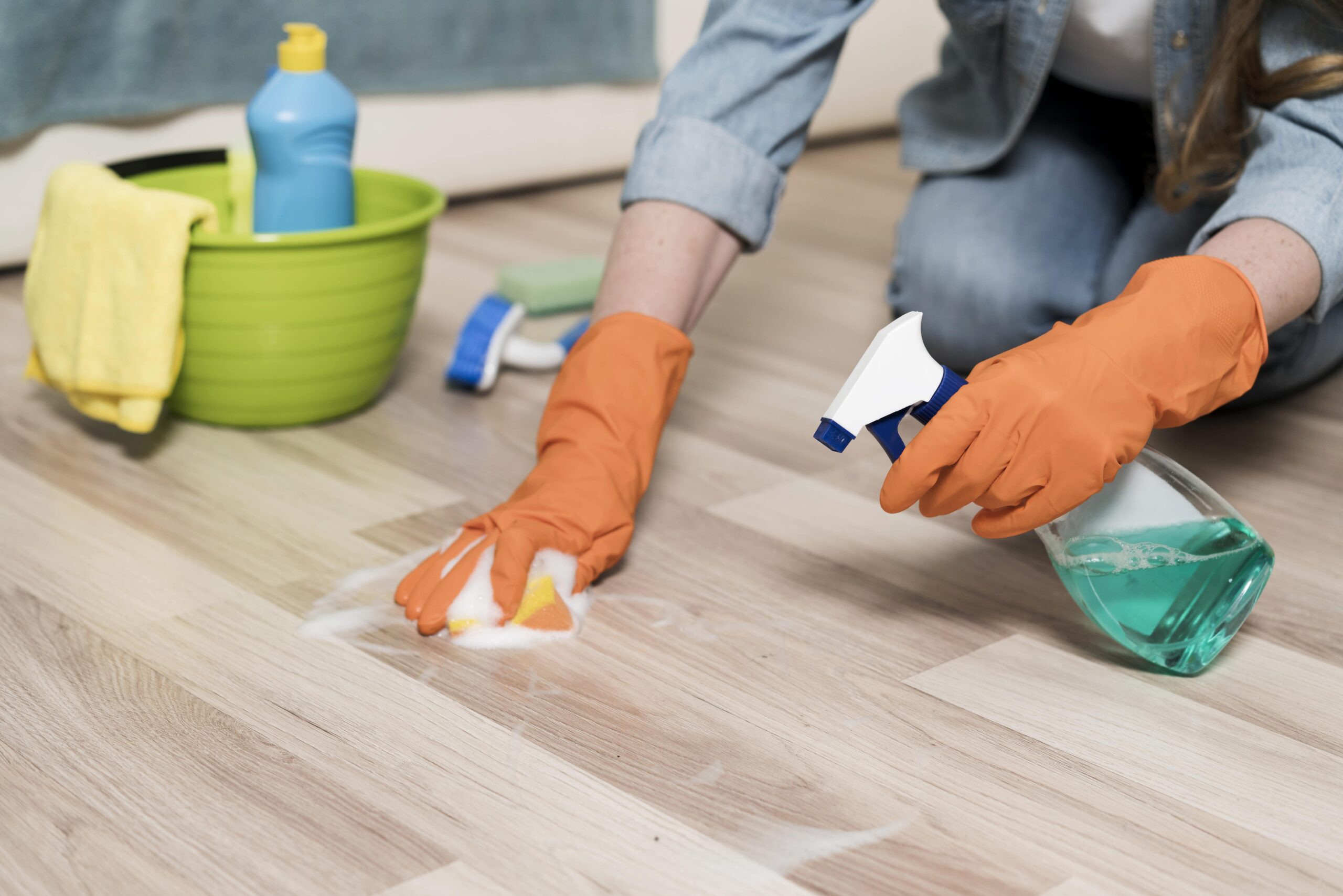 woman-with-rubber-gloves-cleaning-floors-min